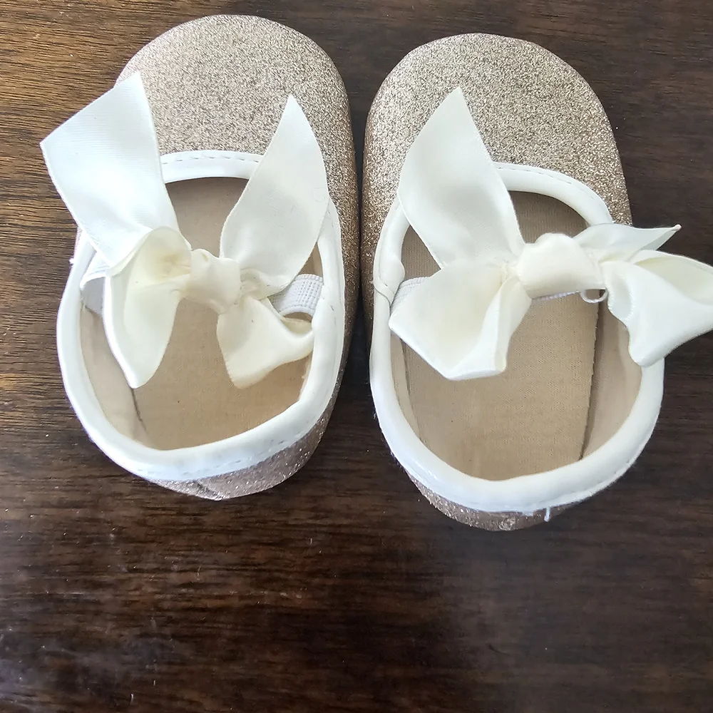3 pairs of baby/girl shoes—soft, floral, and glittery—in various styles.